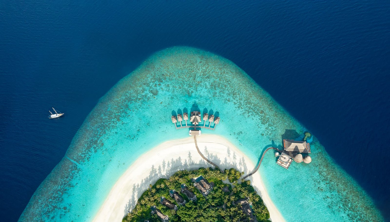 Water villas on stilts over a shallow lagoon in the Maldives