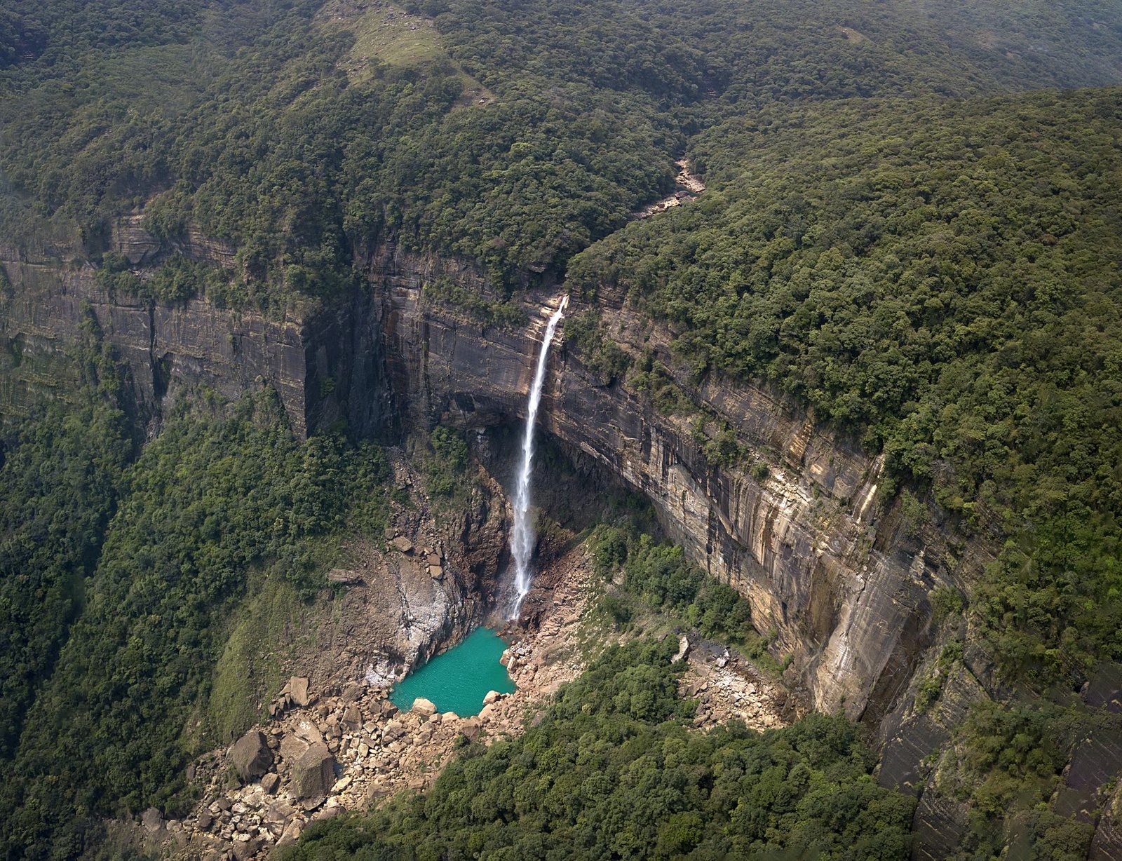 Green hills and a river valley in north-east India