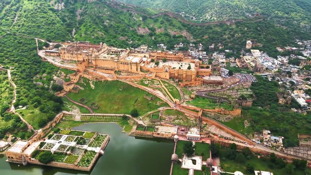 A sandstone fort above a city in Rajasthan at golden hour